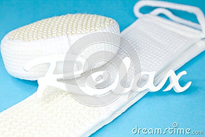 Word relax on sponge and scrubber - Stock Photo
