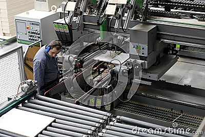 Worker in automatic furniture factory