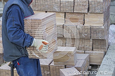 Worker carries packages of beech wood profiles 3