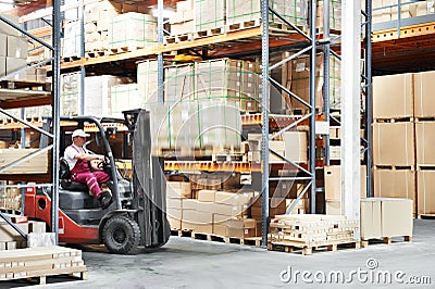 Worker driver at warehouse forklift loader works