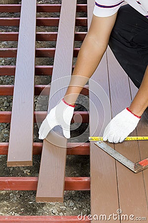 Worker installing wood floor