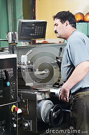 Worker at machining tool workshop