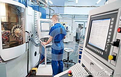 Worker operating CNC machine center