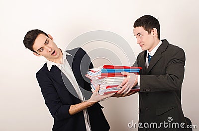 Worker receiving many files from his happy boss.