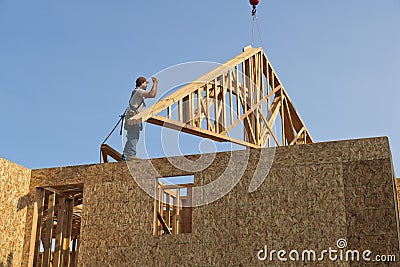 Worker with roof truss frame