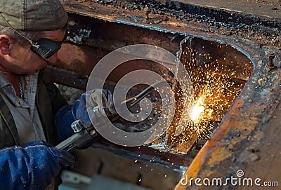 Worker using a propane torch