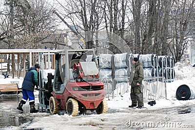 Workers clearing the street from snow