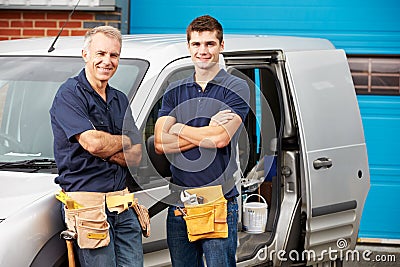 Workers In Family Business Standing Next To Van