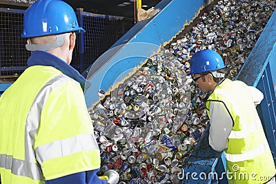 Workers Monitoring Conveyor Belt Of Recycled Cans