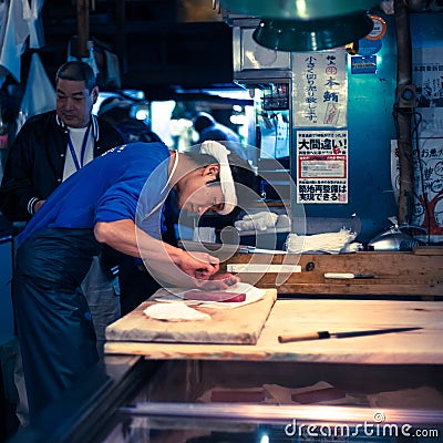 Workers processing Tuna at Tsukiji market in Japan