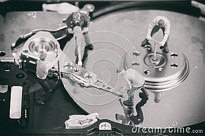 Workers repairing hard disc. Macro photo with retro style effect