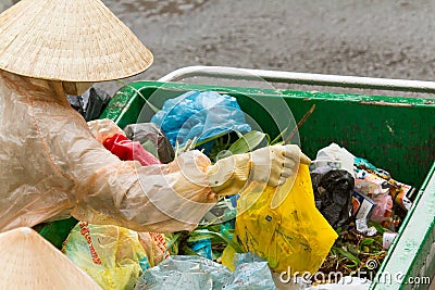 Workers separates the waste on the street for recycling