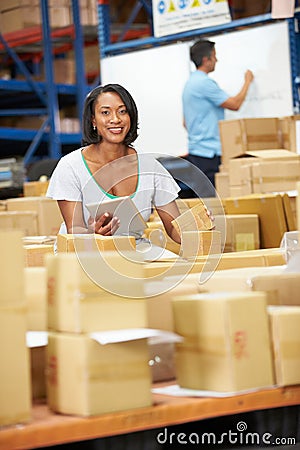 Workers In Warehouse Preparing Goods For Dispatch