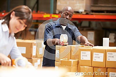 Workers In Warehouse Preparing Goods For Dispatch