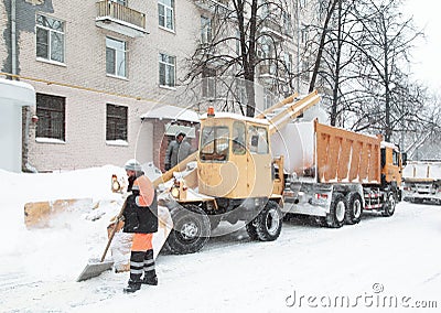 Working people clean the snow on street