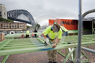 Workmen assemble steel framing.