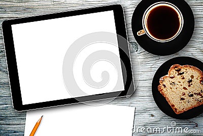 Workplace with digital tablet, notebook, cake and coffee cup