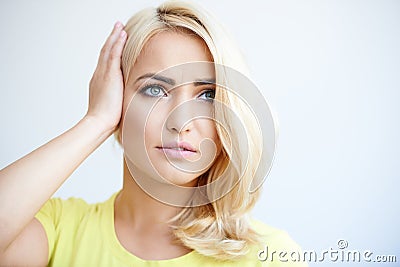 Worried young woman holding her head