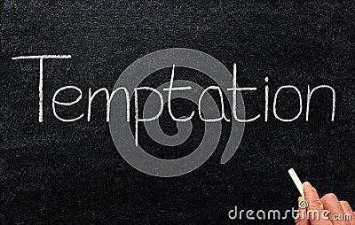 Writing temptation with white chalk on a blackboard.