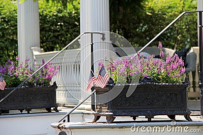 Wrought iron planters and flags on steps of home