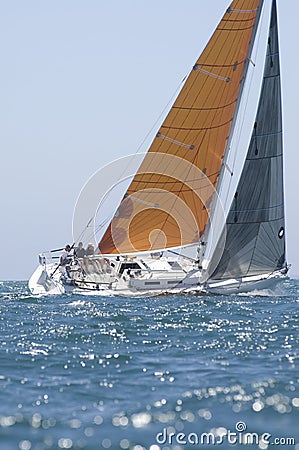 Yacht With Orange Sail Competes In Team Sailing Event