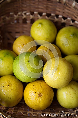 Yellow lemon in basket with natural lighting