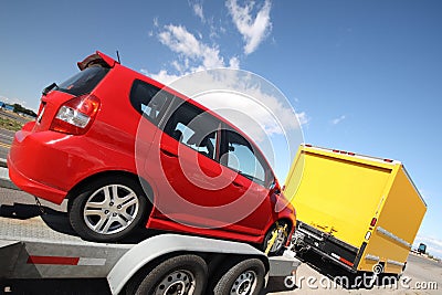 Yellow moving truck pulling a trailer