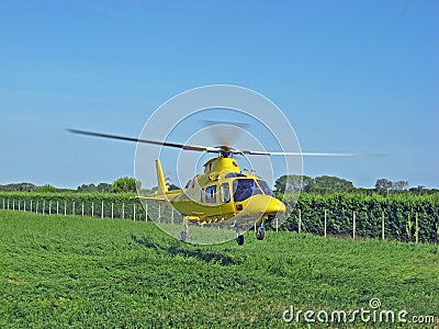 Yellow rescue helicopter air ambulance takes off