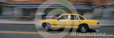Yellow taxi cab in motion
