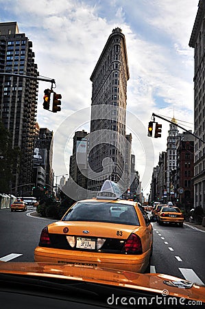 Yellow taxi cabs under the Flatiron Building