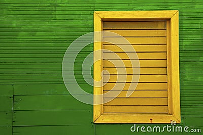 Yellow window on green house