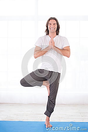 Yoga man doing tree pose