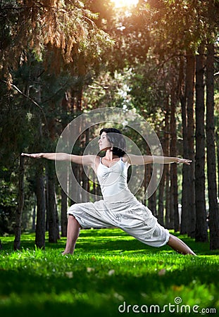 Yoga warrior pose in park