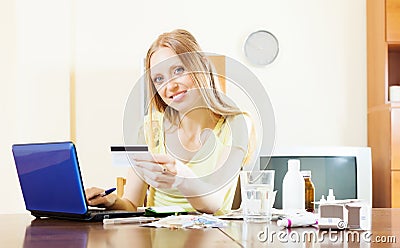 Youbg woman shopping medications on internet from home