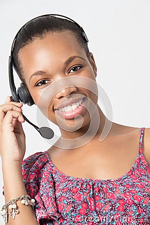 Young african american call center agent laughing.