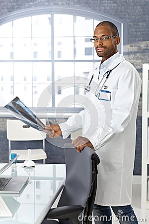 Young afro doctor with xray image