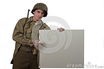 Young American soldier shows a sign