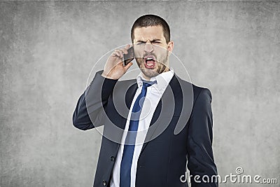 Young angry business man shouting