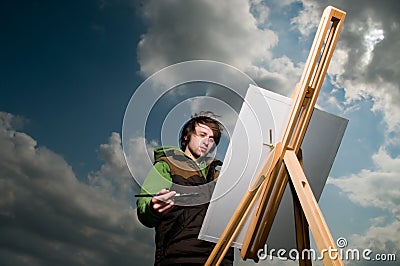 Young artist drawing outdoors