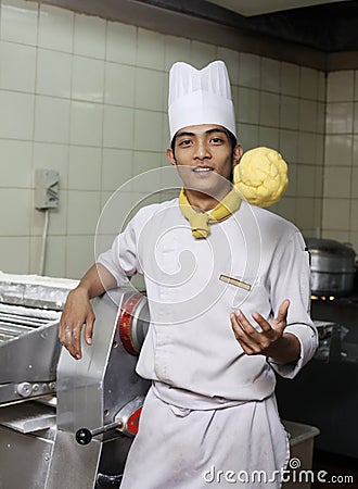 Young asian chef posing