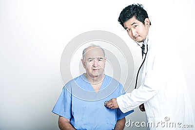 A young Asian Doctor comforting a Senior adult patient