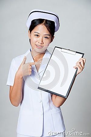 Young Asian nurse point to blank paper on clipboard