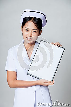 Young Asian nurse show blank paper on clipboard