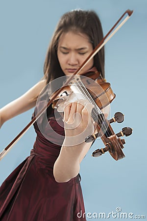 Young asian woman playing the violin