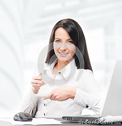 Young and attractive business woman drinking coffee in the office