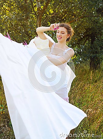 Young attractive woman doing her laundry