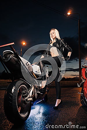 Young attractive woman and motorcycle