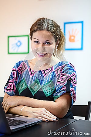 Young attractive woman sitting with laptop at table