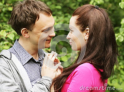 Young beautiful couple in a sweet cheek kiss