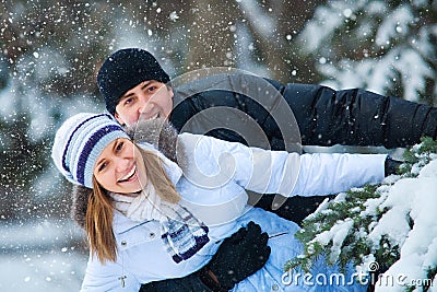 Young beautiful couple in winter park.